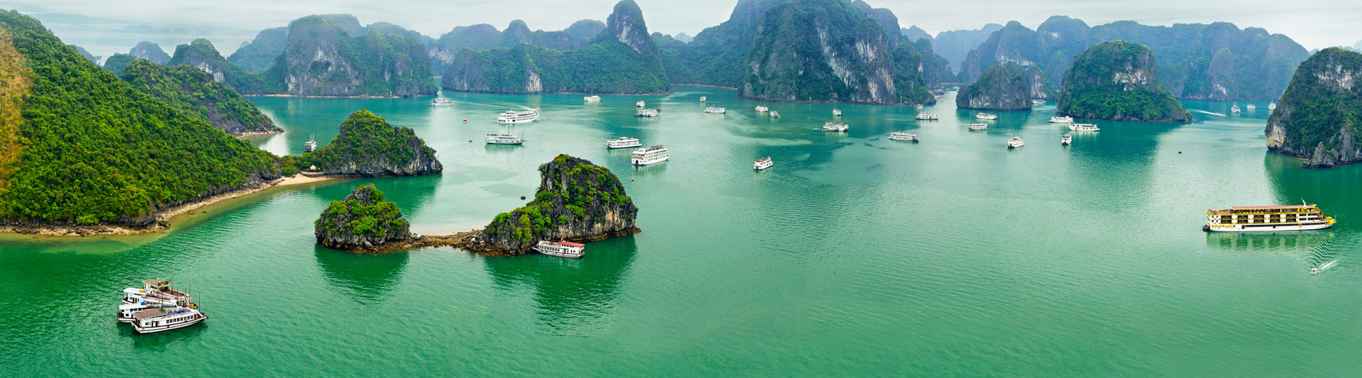 Limestone islands and tour boats in Ha Long Bay, Vietnam